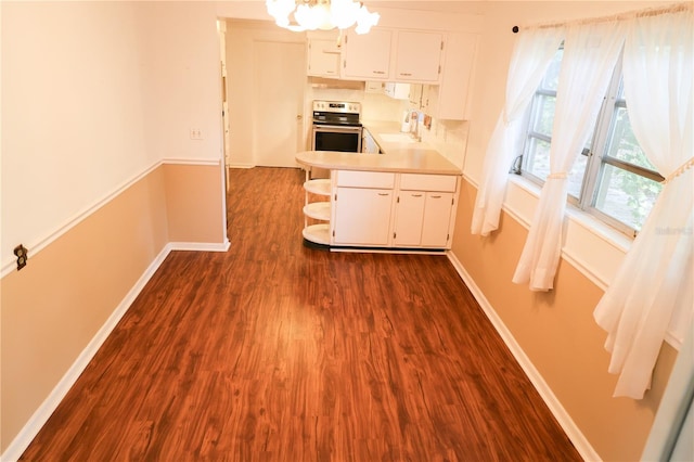 733 Oleander Dr SE, Winter Haven, FL 33880 - kitchen with electric stove, light countertops, dark wood-style flooring, and white cabinets