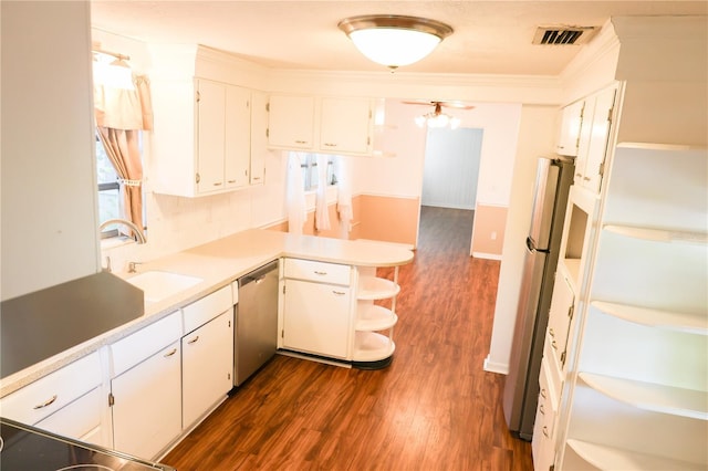 733 Oleander Dr SE, Winter Haven, FL 33880 - kitchen with open shelves, appliances with stainless steel finishes, a peninsula, dark wood-style flooring, and ornamental molding