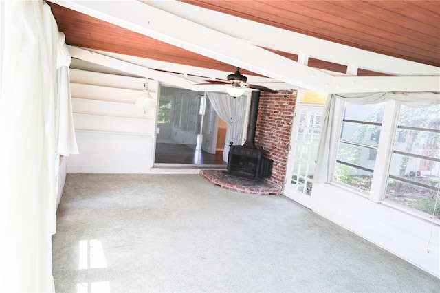 733 Oleander Dr SE, Winter Haven, FL 33880 - unfurnished sunroom with a wood stove and beam ceiling