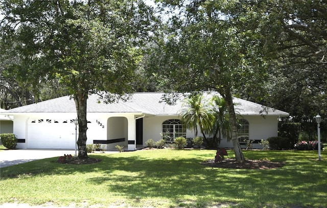 1922 N Torrington Rd N, Avon Park, FL 33825 - ranch-style home with an attached garage, stucco siding, and a front yard