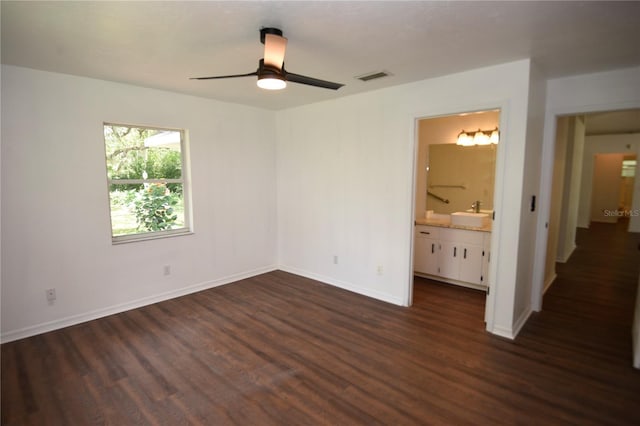 1922 N Torrington Rd N, Avon Park, FL 33825 - unfurnished bedroom with dark wood-style floors, ensuite bathroom, and a ceiling fan