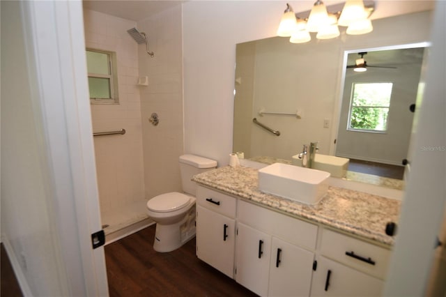 1922 N Torrington Rd N, Avon Park, FL 33825 - bathroom featuring a tile shower, vanity, ceiling fan, wood finished floors, and a chandelier