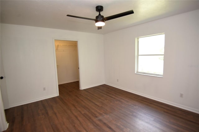 1922 N Torrington Rd N, Avon Park, FL 33825 - unfurnished bedroom featuring dark wood-style flooring, a walk in closet, and ceiling fan