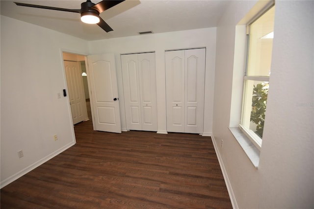 1922 N Torrington Rd N, Avon Park, FL 33825 - unfurnished bedroom featuring multiple closets, dark wood-style floors, and a ceiling fan