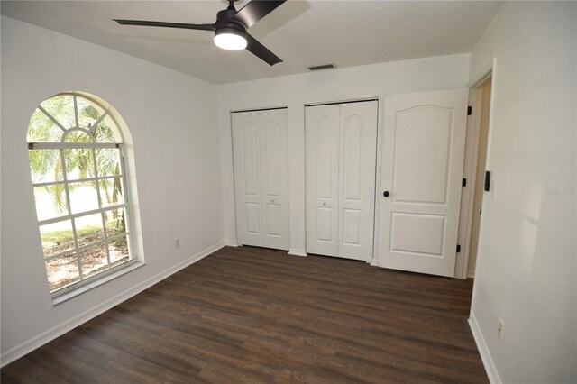 1922 N Torrington Rd N, Avon Park, FL 33825 - unfurnished bedroom with two closets, dark wood-style floors, and ceiling fan