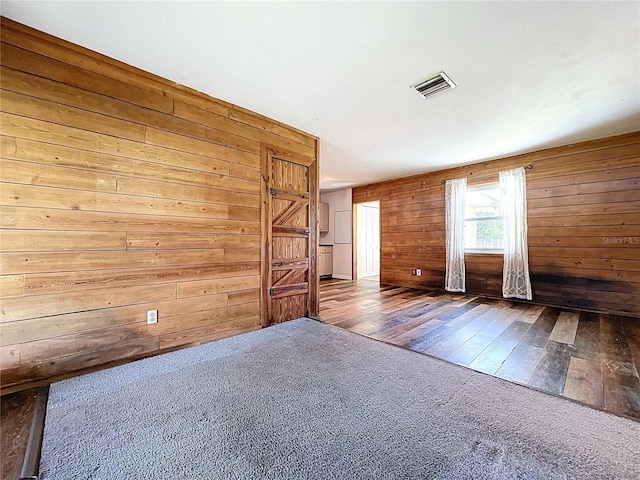 1711 Estes Rd, Bartow, FL 33830 - carpeted empty room featuring wood walls and wood finished floors