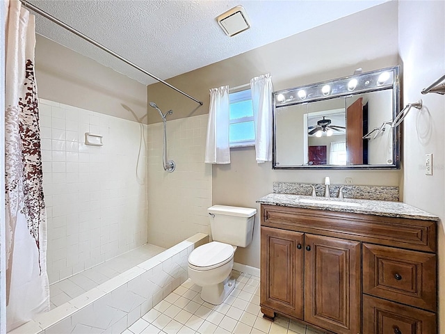 1711 Estes Rd, Bartow, FL 33830 - bathroom featuring tiled shower, vanity, tile patterned flooring, a ceiling fan, and a textured ceiling