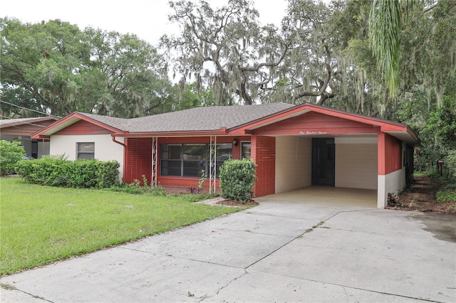 111 Deen Blvd, Auburndale, FL 33823 - ranch-style house with an attached carport, concrete driveway, a front yard, and roof with shingles