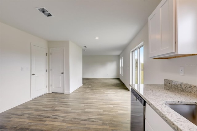 kitchen featuring light stone counters, white cabinets, light hardwood / wood-style floors, and dishwasher