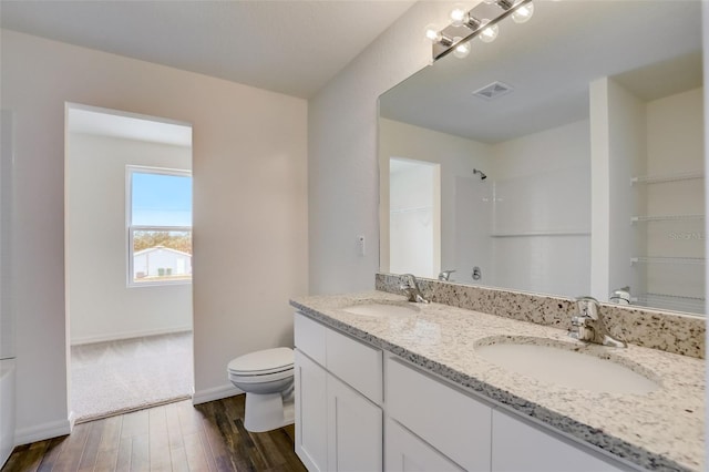 bathroom with vanity, hardwood / wood-style flooring, and toilet