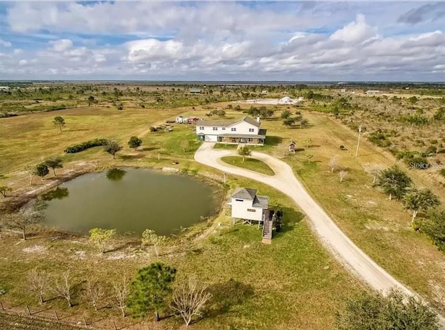 drone / aerial view with a water view and a rural view