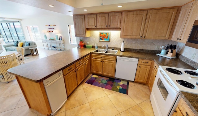 kitchen featuring sink, backsplash, light tile patterned floors, kitchen peninsula, and white appliances