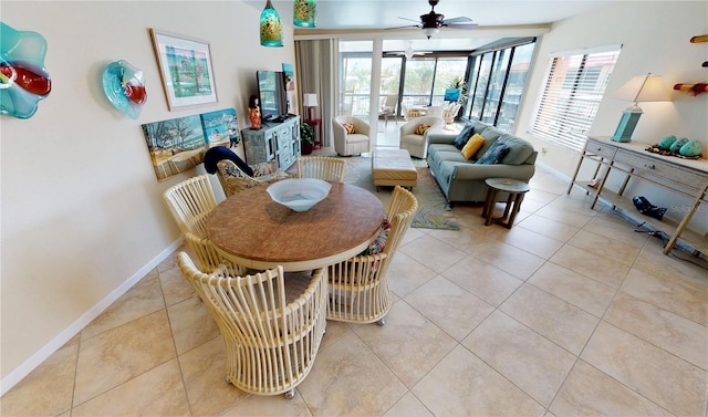 tiled dining area with plenty of natural light and ceiling fan