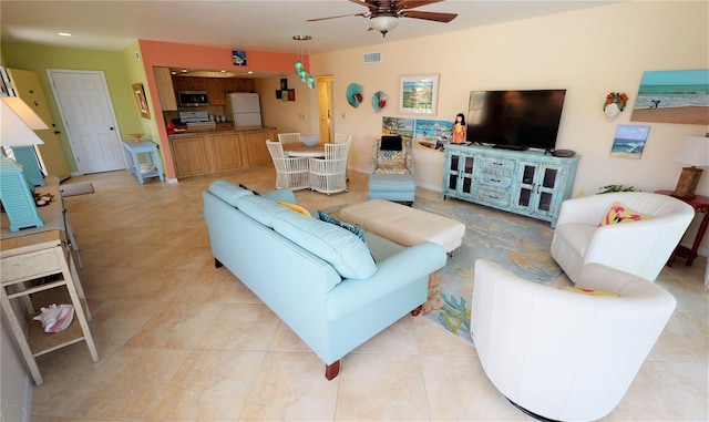 living room with ceiling fan and light tile patterned floors