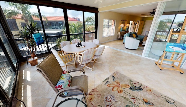 sunroom featuring ceiling fan