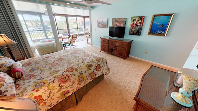 bedroom featuring access to exterior, light colored carpet, and ceiling fan