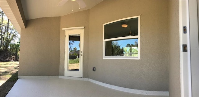 view of exterior entry featuring ceiling fan