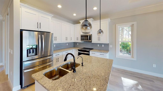 kitchen with light stone countertops, backsplash, light hardwood / wood-style flooring, stainless steel appliances, and pendant lighting