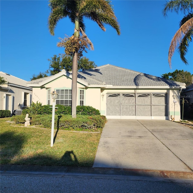 single story home with a garage and a front lawn