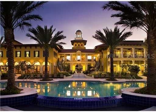 pool at dusk with a patio area