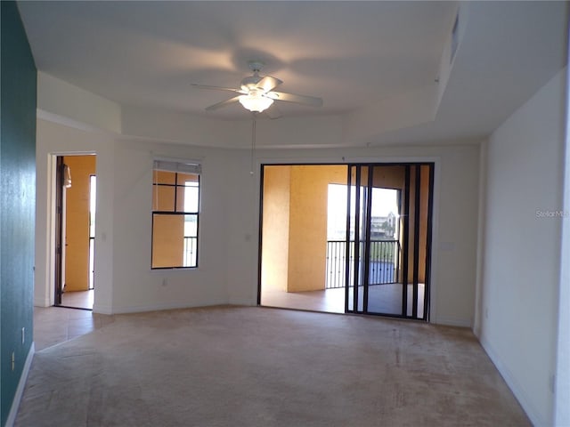 empty room with light colored carpet and ceiling fan