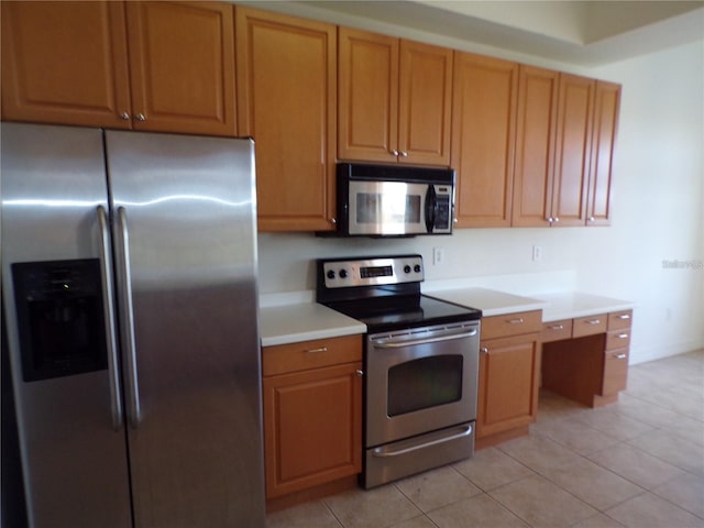 kitchen with stainless steel appliances and light tile flooring