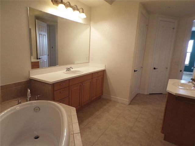 bathroom featuring double sink, tile flooring, oversized vanity, and tiled tub