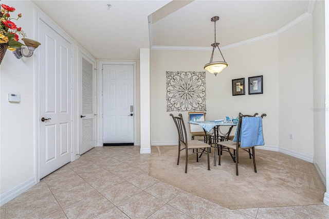 dining space with ornamental molding and light tile floors