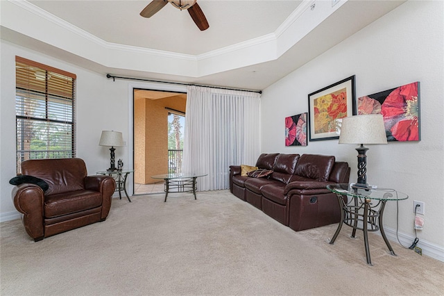 living room featuring light carpet, ceiling fan, and crown molding