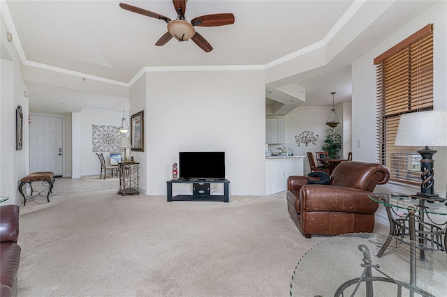 carpeted living room with ceiling fan and crown molding