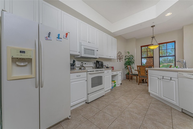 kitchen featuring white appliances, white cabinets, decorative light fixtures, and sink