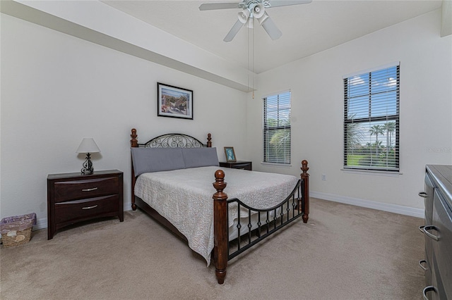 bedroom featuring light carpet and ceiling fan