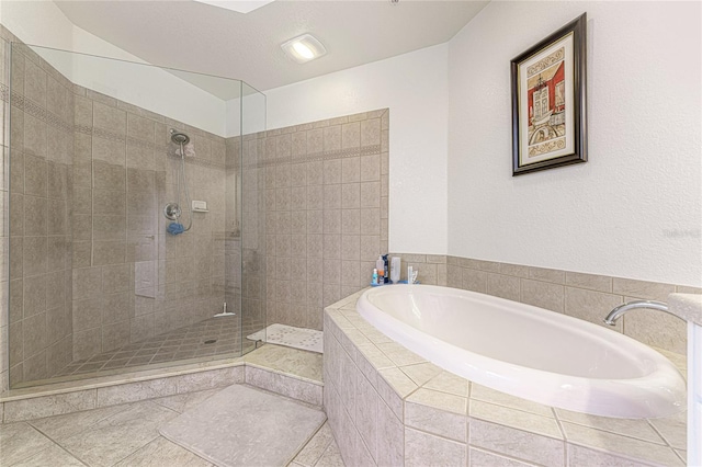 bathroom featuring shower with separate bathtub and tile flooring