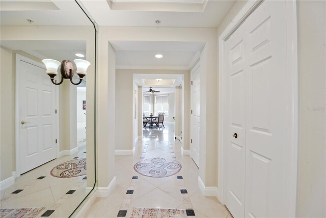 corridor with light tile patterned flooring and baseboards