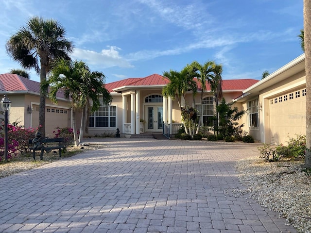 view of front facade with a garage and french doors