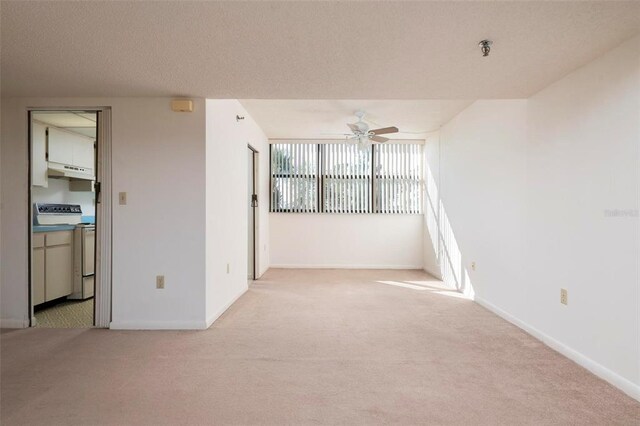 carpeted empty room with a textured ceiling and ceiling fan