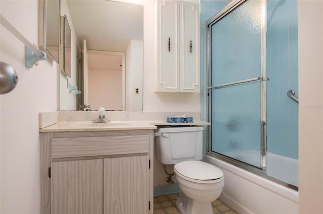 full bathroom with toilet, tile floors, bath / shower combo with glass door, and vanity