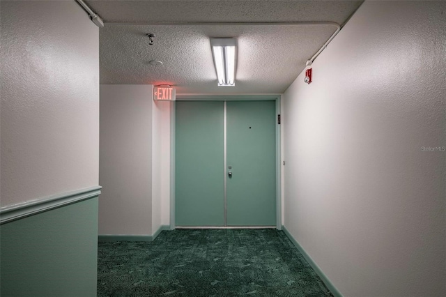 3006 Caring Way Unit 325, Port Charlotte, FL 33952 - corridor featuring dark colored carpet, a textured ceiling, and baseboards