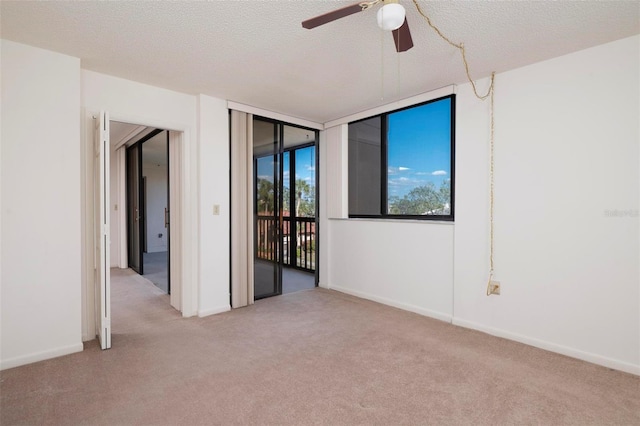 3006 Caring Way Unit 325, Port Charlotte, FL 33952 - carpeted spare room with ceiling fan, baseboards, and a textured ceiling