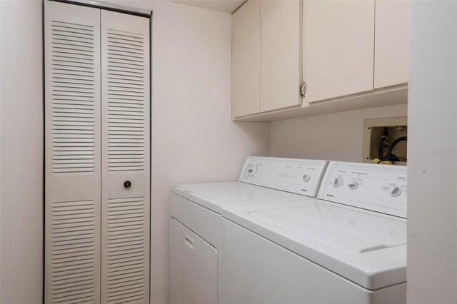 3006 Caring Way Unit 325, Port Charlotte, FL 33952 - laundry area featuring cabinet space and washing machine and dryer