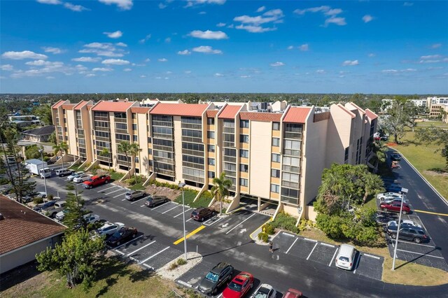 3006 Caring Way Unit 325, Port Charlotte, FL 33952 - view of apartment building / complex featuring uncovered parking