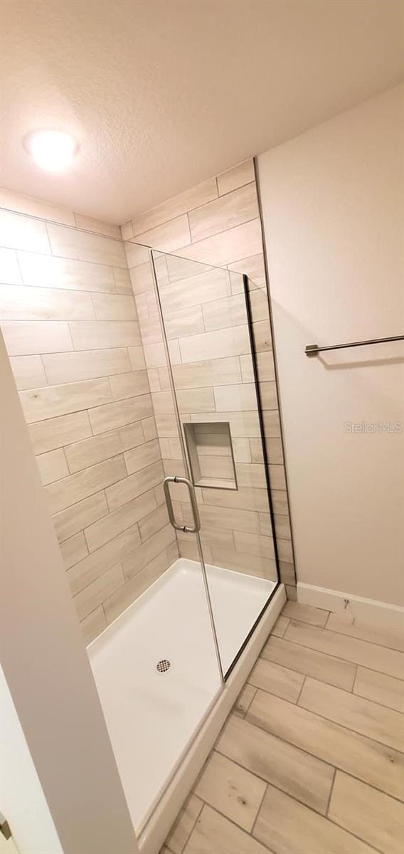 bathroom with a shower with shower door