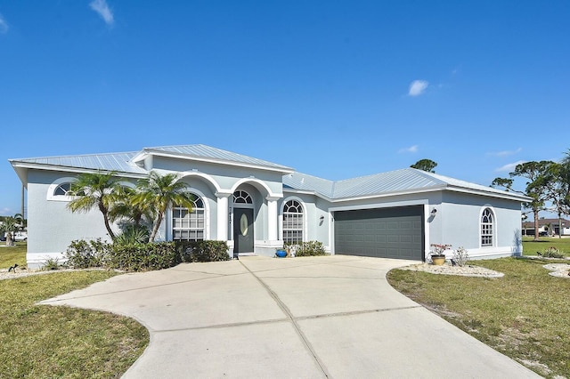 view of front of home with a front yard and a garage