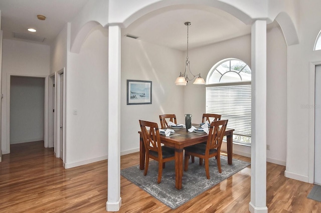 dining area featuring an inviting chandelier and light hardwood / wood-style floors