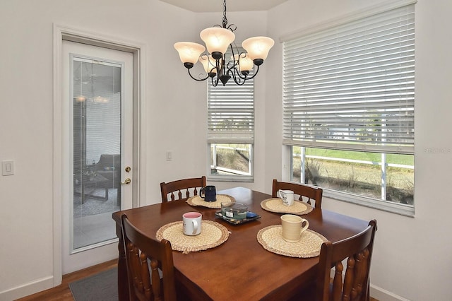 dining area featuring hardwood / wood-style floors and a notable chandelier