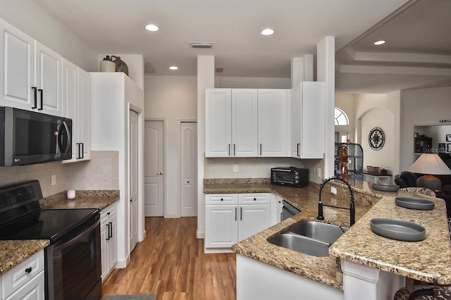 kitchen with light hardwood / wood-style floors, sink, black appliances, and light stone counters