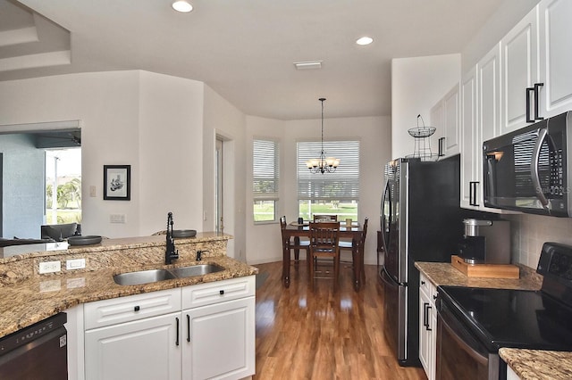 kitchen featuring white cabinetry, sink, a chandelier, and black appliances