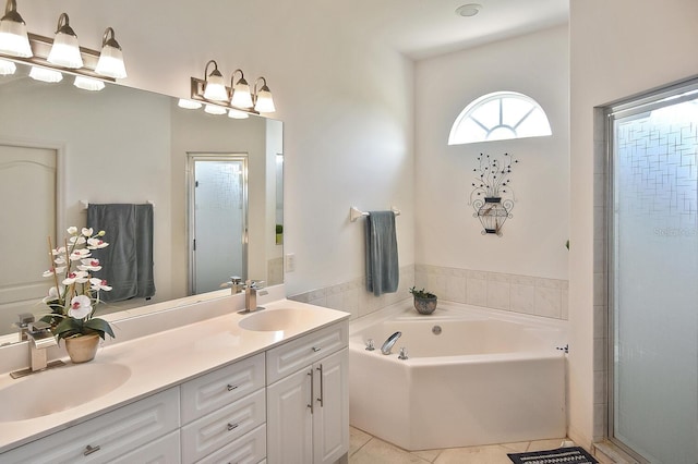 bathroom featuring tile flooring, vanity with extensive cabinet space, dual sinks, and plus walk in shower