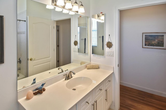 bathroom featuring oversized vanity,  shower combination, and hardwood / wood-style flooring