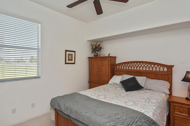 bedroom featuring light carpet and ceiling fan